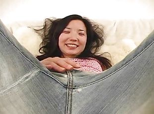 This Asian girl sheds her jeans and fucks her pussy with a toy