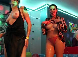 Dancing ladies at the night club get naked and munch cunt