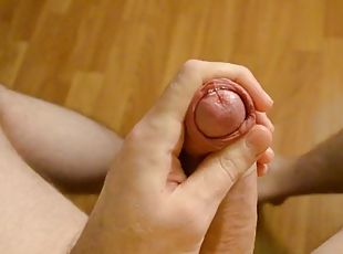 The boy jerks off his cock and cums on the floor