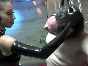 Sexy Asian mistress in latex slaps a slave and spits in his mouth.