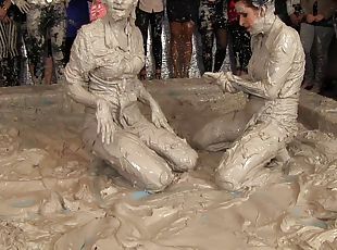 Leather-clad brunette with a sexy body having a catfight in a mudbath
