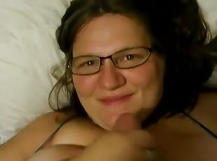 Chubby brunette wearing glasses milks a cock dry on her face
