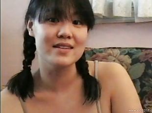 Lovable Asian babe with pigtails getting drilled doggy style