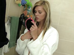 Slim blonde Sindy Vega plays with her shaved pussy in a bathroom