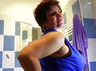 Mature pornstar masturbating with a massive dildo in the shower