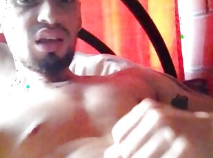 Latino squirts his chest with milk