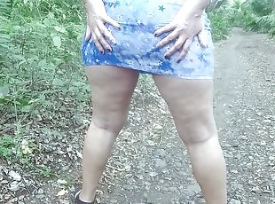 Walking and pissing in short dress outdoors