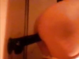 Horny slut fucks a dildo attached to the wall