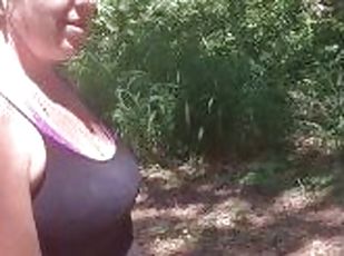 Cute girl with long hair smoking while walking a trail