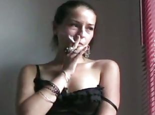 Amateur brunette smokes a cigartette and kneads her boobs