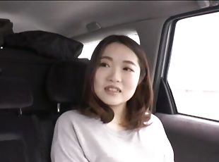 Asian wife takes a vibrator and pleasures her pussy in the car